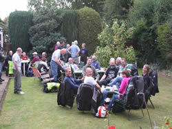 The riders and passengers enjoying tea and cakes