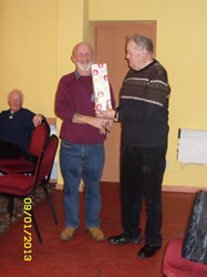 Dave McMahon receives a bottle to pass on to son John