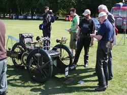 Peter Booth (foreground) shows the Lord Mayor the oldest machine, looking on Martyn Roberts with son Phil taking a photograph.