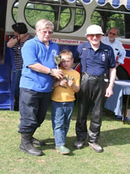 Mike Wills with son Matthew is presented their cup by Peter Booth