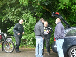 Front left Rob Payne, front right Dave Sketchley sign on Glen Hughes with Martyn Roberts far left.